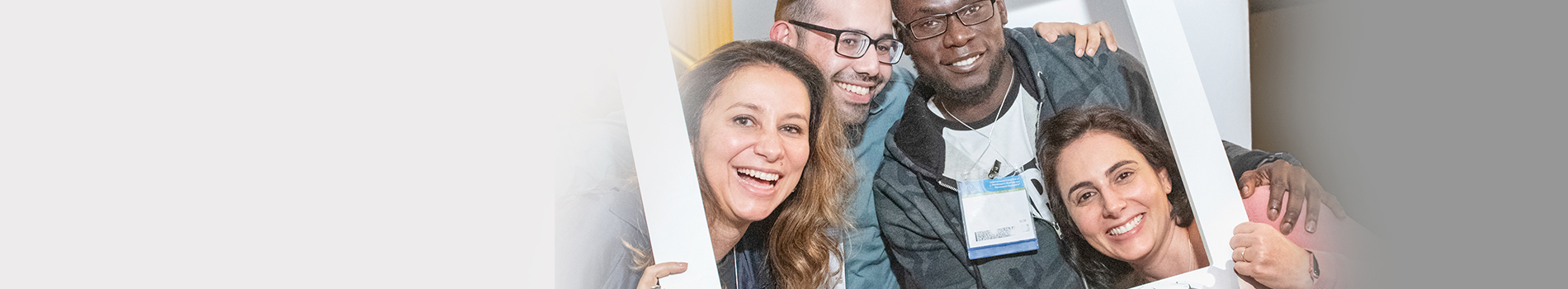 Members smile in front of a lit ferris wheel at an MDS event